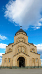 Front view of the Church of the Iveron Icon of the Mother of God in Tbilisi, Georgia, under dramatic sky. Modern Orthodox architecture in a serene urban setting.