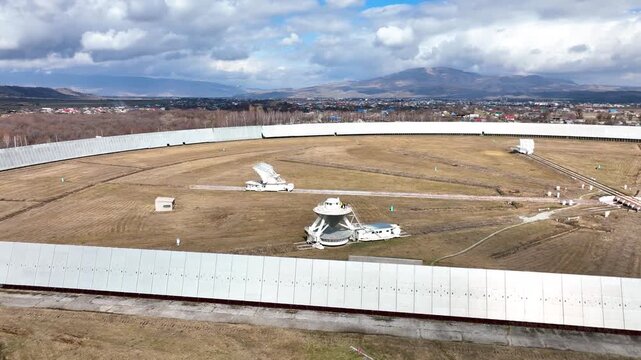 Karachay Cherkessia, Russia - September 12, 2024: A close up top down aerial view of the gigantic circular RATAN 600 radio telescope, focusing on the central receiver structure and the network of radi