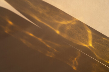 Different glasses for wine, cocktails, drinks, long sun shadow on a light beige background. The concept of wine tasting or summer vacation.