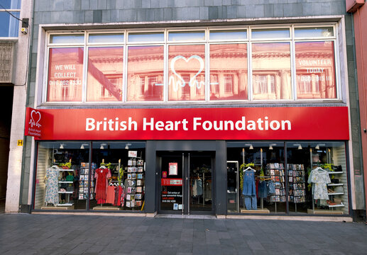 Leicester, England, UK - 9 May 2025: British Heart Foundation charity shop with large upper window featuring a heart shape for articles on non-profit and community support