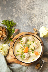 Hearty meatball soup with vegetables and herbs for a cozy meal.