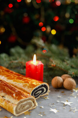 christmas nut and poppy seed rolls with candlelight
