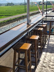 Relaxed atmosphere in an open cafe with natural views. Cafe in a river and rice field area in Indonesia.