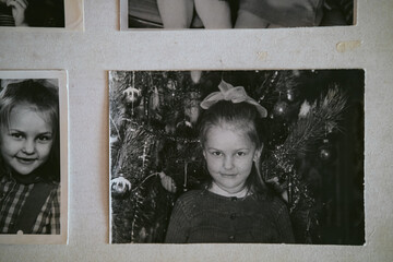Uralsk, Kazakhstan - 22 January, 2025: Black and white old photos of girls, new year. Photo album with photo. Life values concept. Little girl in kindergarten at a matinee. Retro or vintage photo.