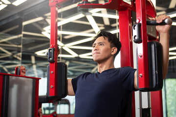 Men practice chest and arm strength on gym equipment