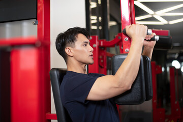 A man practicing chest and arm strength on equipment, close-up shot
