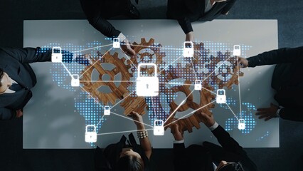 A high-angle view of a business meeting showcasing professionals collaborating over a table with...