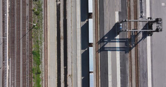 Straight down aerial video of several, many, parallel railroad tracks in a rail yard.