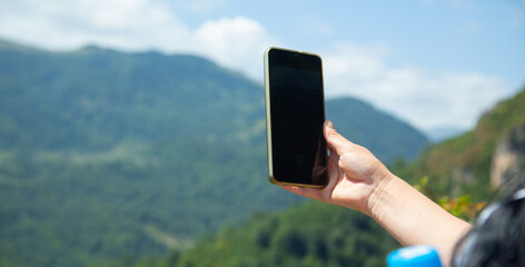 Caucasian human using mobile phone in outdoors.
