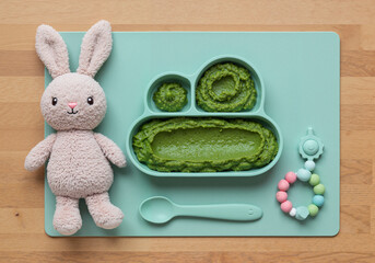 Baby spinach mash in cute divided plate with plush toy
