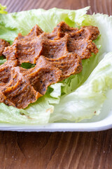 Making raw meatballs ( Turkish: Cig Kofte ) on wooden background	