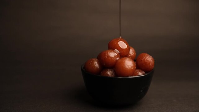 Gulab Jamun, A beloved dessert in Indian and Pakistani cuisine, drenched in sweet syrup