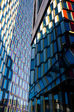 Reflections of colored glass panels on modern office tower fa&ccedil;ade, Scandinavian corporate design showing clarity, geometry and copy space background for branding, posters and layouts