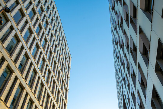 Parallel façades of modern office towers in perspective, contemporary corporate architecture showing geometry, clarity and minimalist copy space background for branding and editorial uses