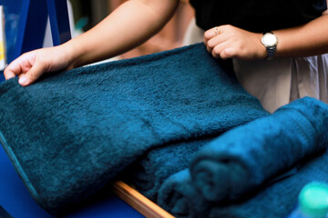 close up of hands rolling up a towel