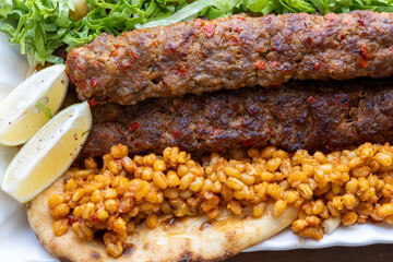 Close-up of traditional Turkish shish kebabs on oval plate