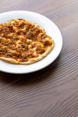 Traditional Turkish dish mini lahmacun in close-up