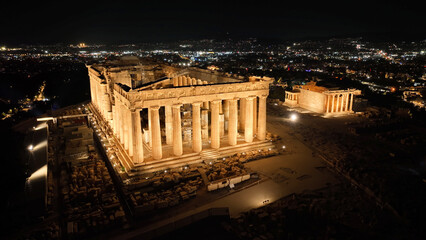 Aerial drone night shot of iconic illuminated world heritage site of Acropolis of Athens historic...