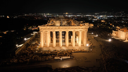 Aerial drone night shot of iconic illuminated world heritage site of Acropolis of Athens historic...