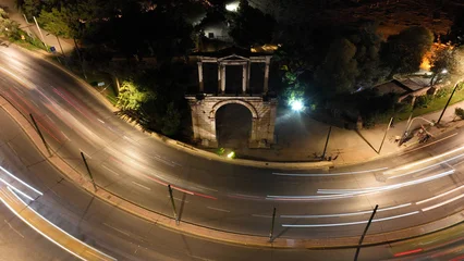 Fototapete Mediterranes Europa Aerial drone slow shutter night shot of illuminated Gate of Hadrian in historic centre of Athens, Attica, Greece  © aerial-drone