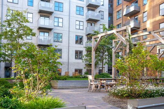 Urban green spaces integrated with Stockholm apartment architecture, landscaped areas reflecting sustainable living and Scandinavian design with modern geometry and corporate identity