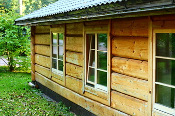 A rustic log cabin featuring a metal roof and windows, ideal for outdoor uses such as camping or...