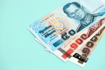 Thai baht money bills in big amount on blue. Finance and banking concept