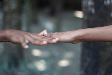 Two hands reaching out to touch, symbolizing connection and unity