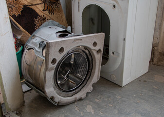 Disassembled washing machine drum and parts prepared for repair or recycling