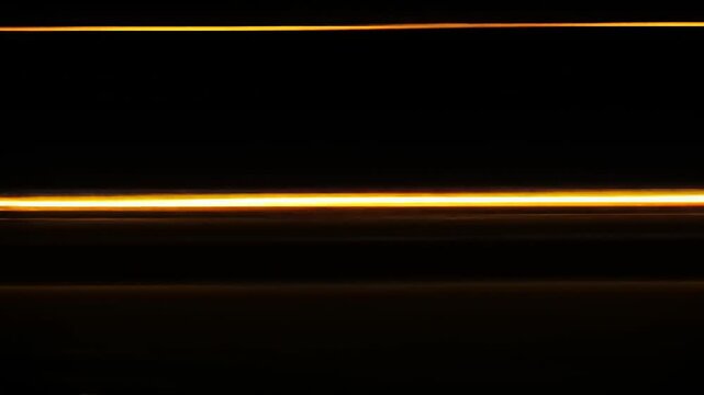 Two parallel streaks of golden light, starkly contrasting against a dark background, create a powerful and modern visual.