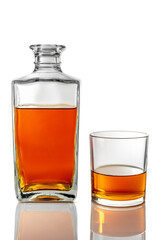 Whiskey glass near decanter glass bottle with whisky isolated on white with clipping path included