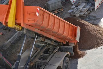 Dump truck unloading soil at construction site   © lisica1