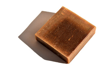 square brown piece of natural soap on white background top view