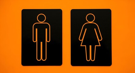 Modern male and female restroom signs on orange background