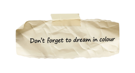 Don't forget to dream in colour motivational quote on torn paper background