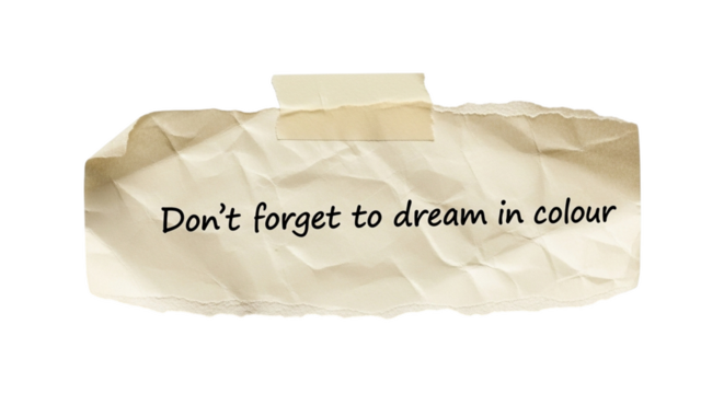 Don't forget to dream in colour motivational quote on torn paper background