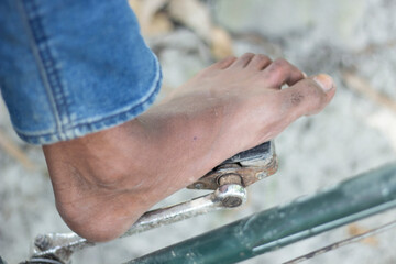 Barefoot persons foot on a bicycle pedal
