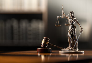 Legal Concept: Themis is the goddess of justice and the judge's gavel hammer as a symbol of law and order on the background of books
