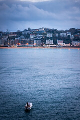 Small boat sailing in La Concha bay at Donostia-San Sebastian, at the Basque Country.