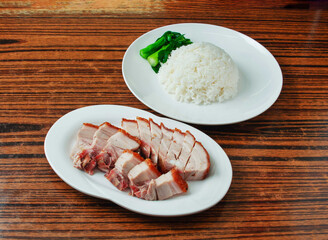 Crispy Skin Chinese Roast Pork Belly Siu Yuk with Steamed Rice and Choy Sum in white platter on...