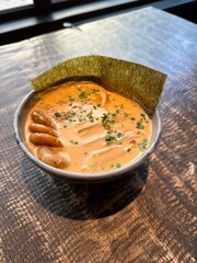 Delicious bowl of spicy ramen with shrimp and seaweed