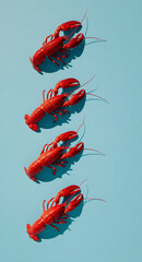 Four red cooked lobsters are arranged in a row on a bright blue background