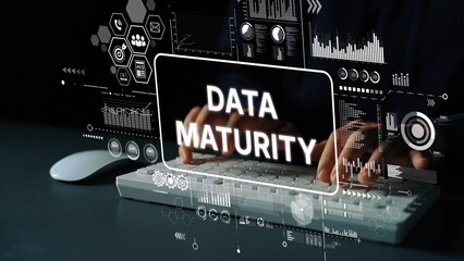 Business Concept of Data Maturity with Hands on Keyboard and Digital Graphics in Background....