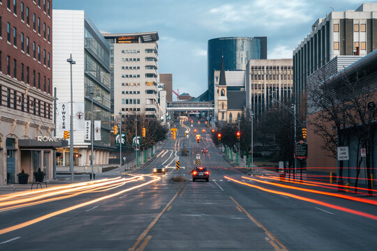 Grand Rapids, Michigan, December 30, 2023: Vehicle light trails streak along the Medical Mile, the city's hospital and research corridor, with downtown buildings at dusk.