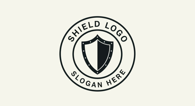 Naklejki A circular emblem featuring a stylized shield divided into black and white halves, enclosed by text indicating "SHIELD LOGO" and "SLOGAN HERE" against a plain background.