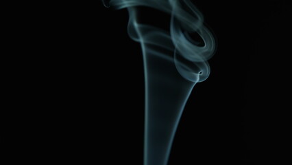 Smoke rings trail rising gently flowing from candle put out after deep focus