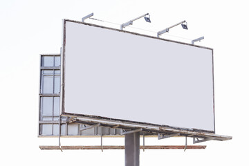 Obraz premium Blank billboard on white sky background. Large outdoor advertising space for commercial promotion and marketing. Empty signboard template for information banner or public business campaign.