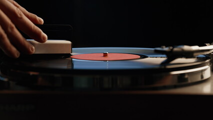Man hand cleaning record playing on vintage turntable closeup. Macro vinyl disc