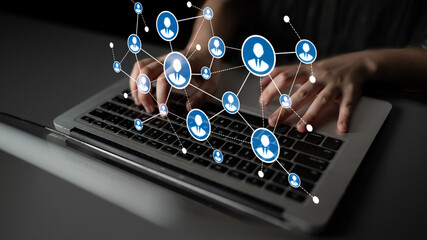 A person typing on a laptop keyboard, surrounded by digital user icons that symbolize networking and online communication in a modern professional setting. Tessel