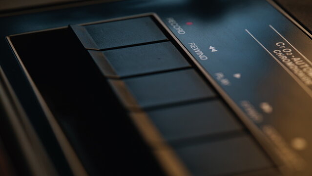 Macro retro player buttons indoors. Closeup detailed black plastic knobs in room